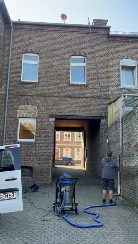EMS reinigt eine Dachrinne mit Teleskop-Sauganlage vom Boden aus